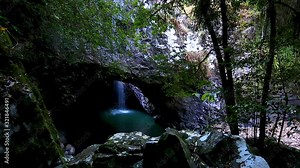 Locked off motion of the waterfall and creek of Natural Bridge in Springbrook National Park,a natural rock arch with a stream flowing through the arch,also home to a colony of glowworms,Queensland