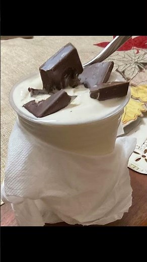 Costco vanilla soft serve ice cream with Hershey caramel milk chocolate square. ￼