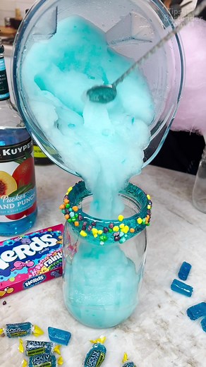 Cotton Candy Topped Jolly Rancher Slush #tipsybartender #candy #jollyrancher #nerds #slushy #blue