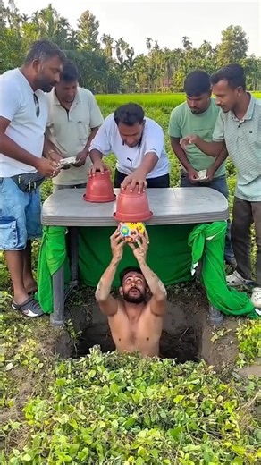 doing fake magic to disappear ball from the box.