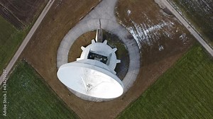 Raisting, Germany Bavaria - December 12, 2020: Large white radio telescope satellite communications parabolic dish called the Erdfunkstelle Radom built in the 1960s near Munich and the Alps.