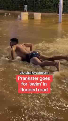 Prankster Goes for Swim in Flooded Road