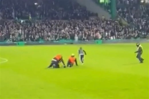 Young Celtic pitch invader sends stewards crashing into each other as fans cheer