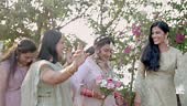 Indian bride entry accompanied by her joyful bridesmaids. Adorned in...