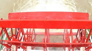 Rotating paddle wheels of a Steam River Boat sailing along the Mississippi River New Orleans Louisiana USA