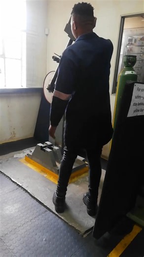 DROPPING HEAVY HAMMER BREAKING MACHINED STEEL SAMPLE FOR IMPACT TEST ON CHARPY MACHINE IN LABORATORY