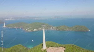 Aerial fly over green forest mountain with Aerial ropeway transit ART in tropical island. Scenic Aerial tramway in a cove.