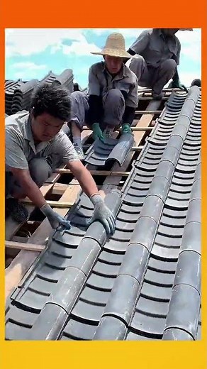 Villagers working together to install the roof of a traditional house in strong unity#communitywork