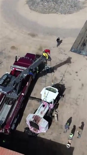 Drone view of us grabbing a brush machine with the NRC 65-ton rotator.
