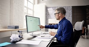 Accountant Using E Invoice Software At Computer In Office