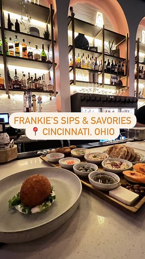 Maria 🤙🏼 Solo Travel + Group Tours on Instagram: "Don’t sleep on this new Cincinnati restaurant 🔥 Frankie’s Sips & Savories (@frankiessips) can be easily missed if you’re not looking for it, but it does have a great location downtown on Garfield Place. This quaint and cozy bar and restaurant is family-run and is a tribute to Frank, their father, who founded Gold Star Chili! With tons of family photos hanging on the wall, and the owners being incredibly inviting, it’s easy to feel like you’re 