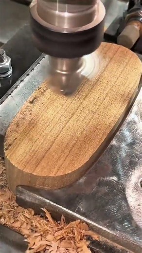 Using a high speed milling machine to carve out a smooth circular depression into a solid wood block