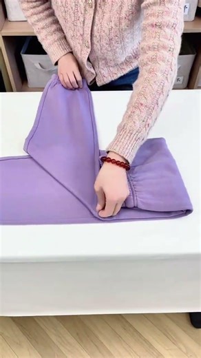 A professional organizer teaches you how to fold your sweatpants into a book making th