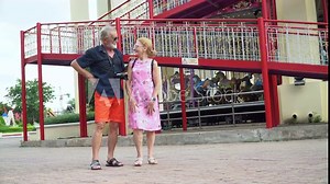 Happy senior couple at the amusement park outdoors in summer. crazy old man and funny mature woman having fun in vacation