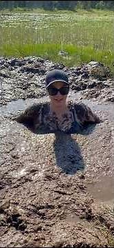 Woman jumps and sinks in the mud but saves herself again.