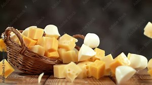 Cheese Explosion, A dramatic explosion of cheese chunks — cheddar, mozzarella, gouda and parmesan — bursting from a wicker basket.