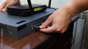 Connecting a router, router to the Internet network via an optical cable - patch cord with an adapter. Operation and reception of a network signal. Equipment for Internet services. Stock Video