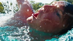 Man swims in the pool. Underwater view of the person swimming in the...