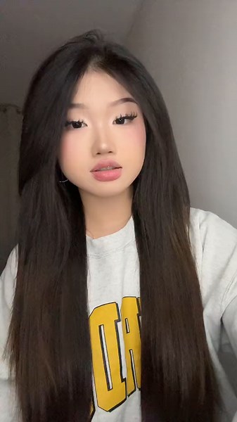 Individual with Dark Brown Hair in Casual Outfit
