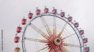 amusement park, high roller, metal construction, observation wheel, bright multicolor Ferris wheel with observation cabs at an amusement park with metal construction of an attraction Ferris wheel