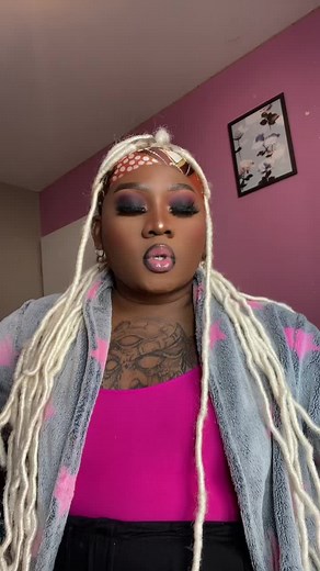 Person with White Dreadlocks in Pink Robe