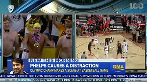 WATCH: Michael Phelps jumps out of a curtain at an Arizona State Sun Devils basketball game in a speedo to distract opposing team's player shooting free throws... and, of course, he missed both free throws. | Good Morning America