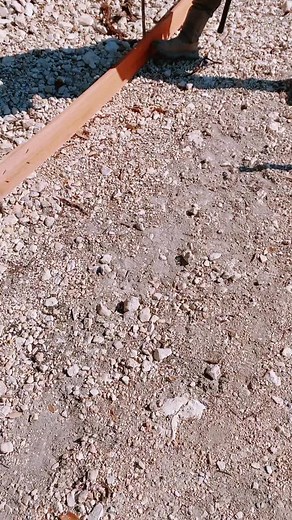 Construction Worker Uses Hammer on Metal Pipe