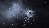 Slow motion close up locked down shot of a bullet piercing through a...