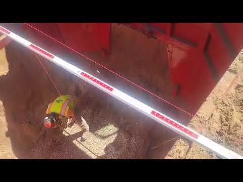 Using a plumb bob and grade rod to set a box