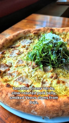 Tribute Pizza on Instagram: "We handed the keys over, and Chef Drew Deckman really took the wheel. 2026 Chef Collab #001 is a weekly pizza unlike anything we have ever done before, and we're really excited to share it. Tomatillo crema verde. Slow-roasted pork belly. Smoked Venus clams from Baja. Mozzarella + Oaxaca. Arugula & fennel salad. 3-year aged extra anejo goat cheese. Only a dozen a day, dine in only, this week only, while it lasts."