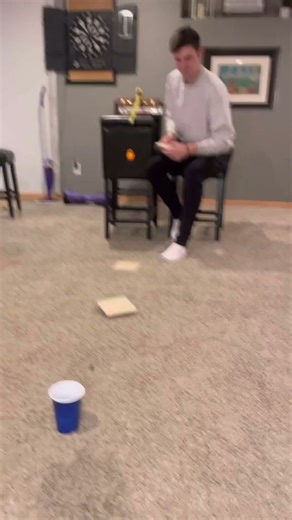 Ping pong trick shot bounces across the room into a cup