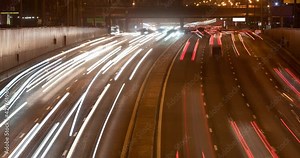Traffic on highway at night. Time lapse of car lights trails