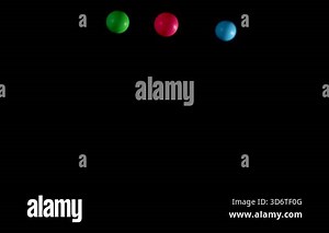 Multicolored balls bouncing against a black background