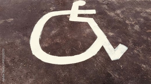 Accessible Parking Spaces Specifically Designed for Individuals with Disabilities and Needs. Detailed view showcasing a designated handicap parking space that highlights its accessibility features.
