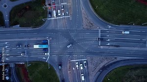 Overhead view: Painted lines guide car traffic in highway intersection