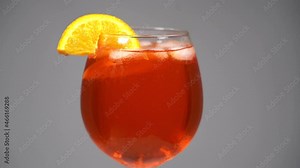 glass of Aperol Campari spritz cocktail with ice and orange - typical Venetian beverage made with Prosecco sparkling white wine - Italian aperitif made in Venice