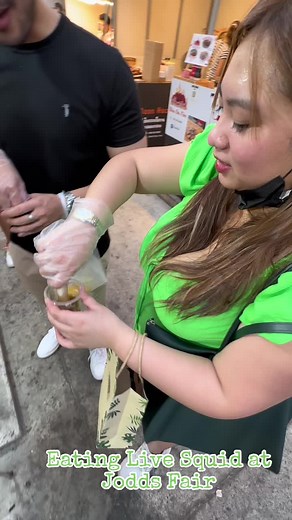 Eating Live Squid: Delicious Seafood Experience in Jodds Fair