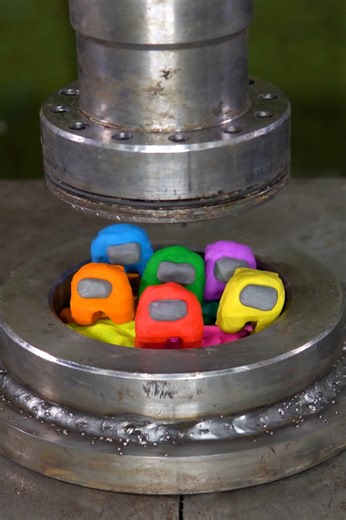 Hydraulic press crushing colorful clay figures