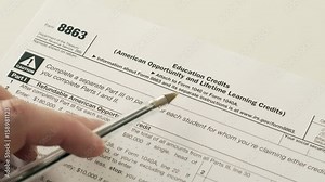 An anonymous person reading the Internal Revenue Service form 8863 which is used for income tax reduction or credits for education fees that have been paid by the claimant.