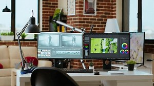 Empty workspace creative studio used for mixing music and editing timelines for a cinematic video shoot. Living room desk with professional tech tools for post production and filmmaking.