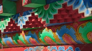 Close up of traditional colorful religious designs on a Nepalese temple, Nepal
