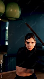 A woman fights with a samurai sword and learns martial art. Fighting with a samurai sword Katana. Samurai concept. Vertical video