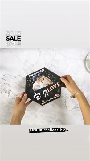 People are going crazy for this handmade scrapbook photo album explosion box.