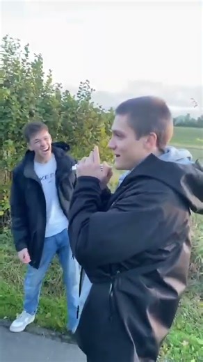 Guys use a flashlight to lure a pig closer to them!