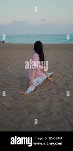 girl in splits on the beach