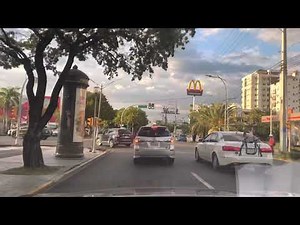 4K Driving Dominican Republic Santo Domingo Av Churchill. La Sirena parking lot Sunset City Views