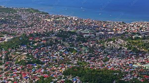 Locked off aerial high over the homes and buildings of Surigao City, Philippines