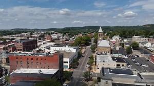 A slow forward aerial establishing shot of the city center of Lancaster, Ohio, the county seat of Fairfield County.
