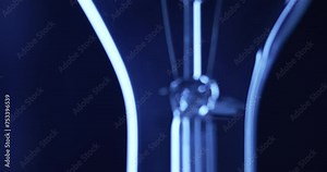 Clear Light Bulb Illuminating With Slow Camera Tilt