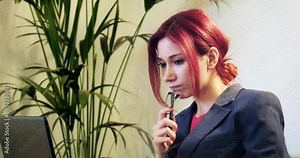 A moment of a young, beautiful businesswoman in office attire, diligently working with her laptop computer outside the office environment